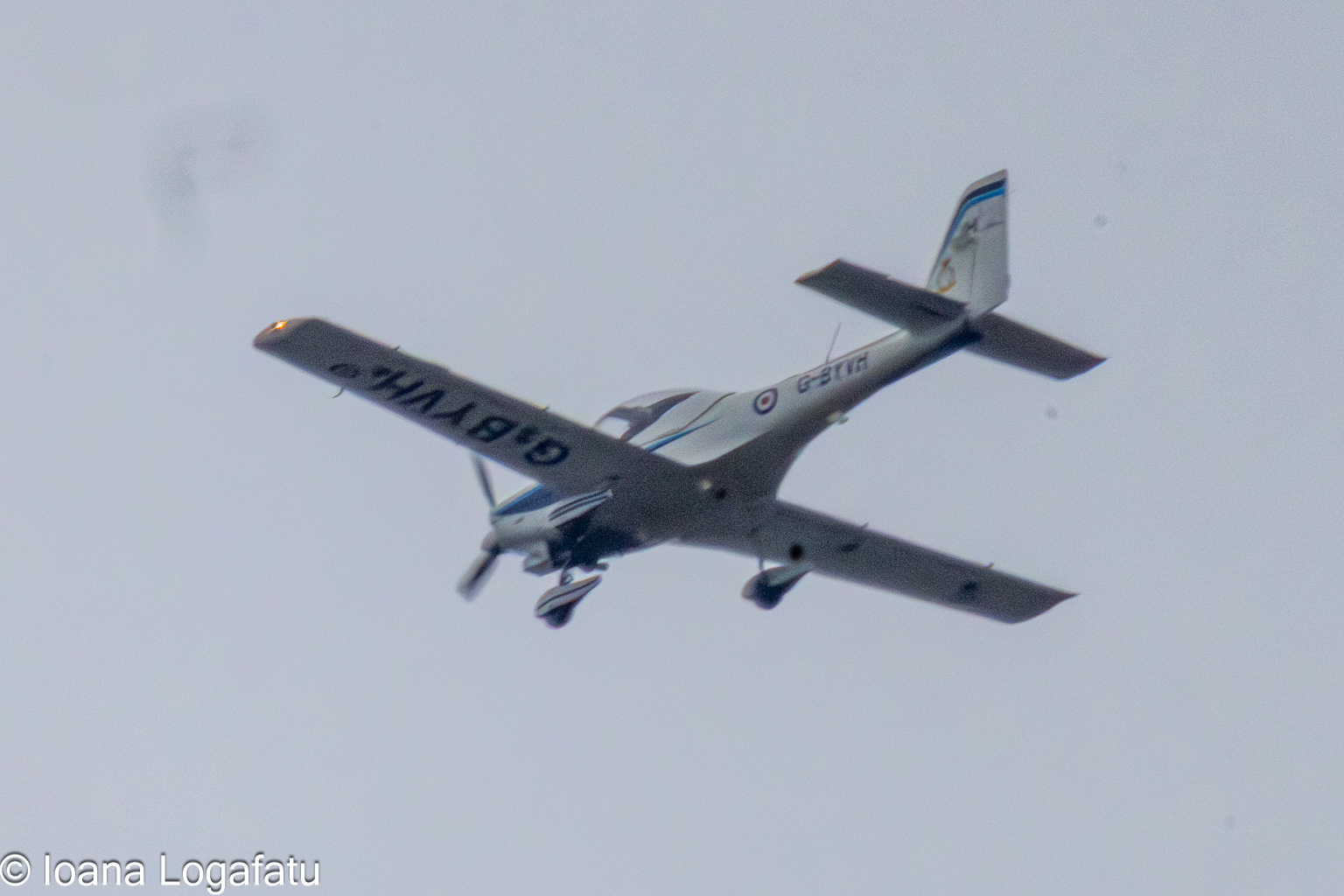 Bright aircraft soaring through the cloudy sky